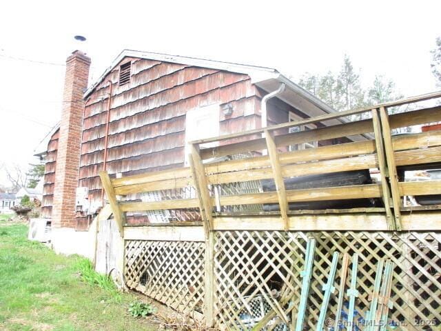 37 Foley Ave, Shelton, CT 06484 - view of side of home with ac unit, a wooden deck, and a chimney