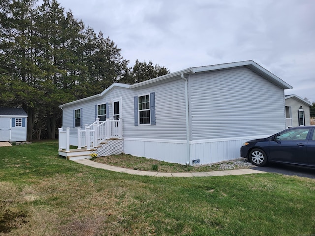 15 Circle Dr, Stonington, CT 06378 - view of front facade featuring an outbuilding, a front yard, and a shed