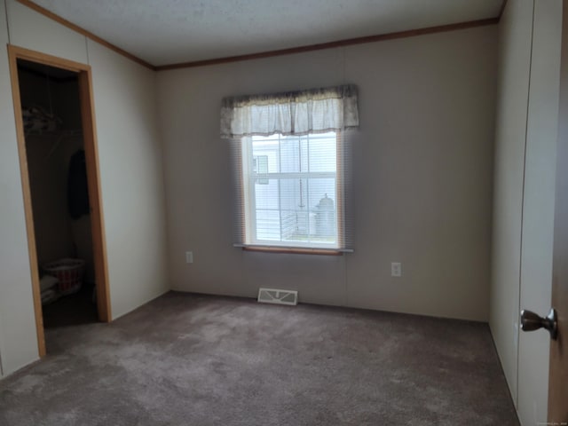 15 Circle Dr, Stonington, CT 06378 - unfurnished bedroom with crown molding, carpet flooring, and visible vents