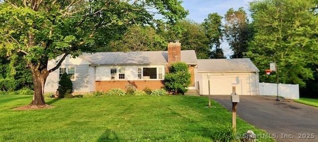 447 Howellton Rd, Orange, CT 06477 - ranch-style house featuring driveway, an attached garage, a chimney, and a front lawn