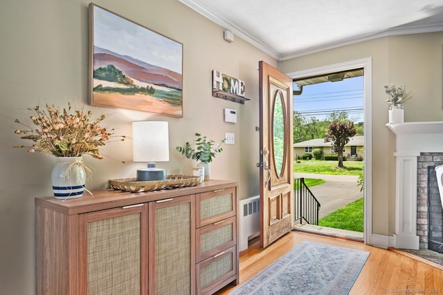 447 Howellton Rd, Orange, CT 06477 - entrance foyer featuring crown molding, light wood-type flooring, and a fireplace