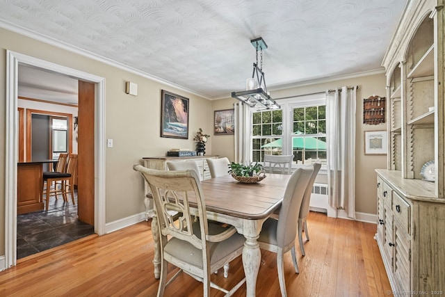 447 Howellton Rd, Orange, CT 06477 - dining room with light wood-style floors and crown molding
