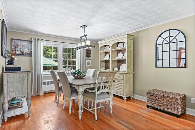 447 Howellton Rd, Orange, CT 06477 - dining space with light wood finished floors, ornamental molding, radiator, and a chandelier