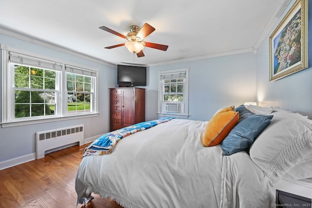 447 Howellton Rd, Orange, CT 06477 - bedroom with radiator, multiple windows, ornamental molding, wood finished floors, and a ceiling fan