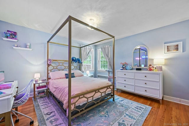 447 Howellton Rd, Orange, CT 06477 - bedroom featuring radiator, wood finished floors, and cooling unit