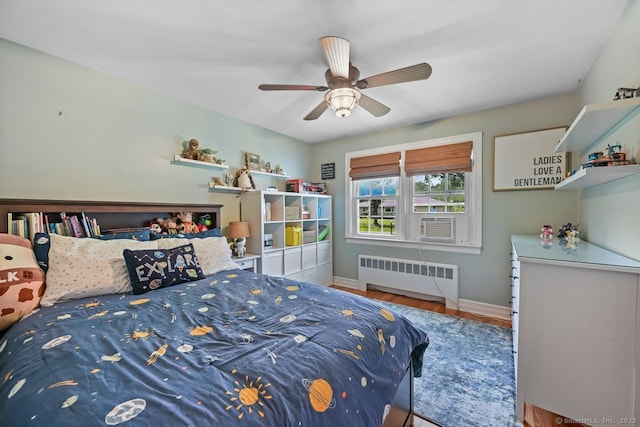 447 Howellton Rd, Orange, CT 06477 - bedroom featuring radiator, wood finished floors, and a ceiling fan