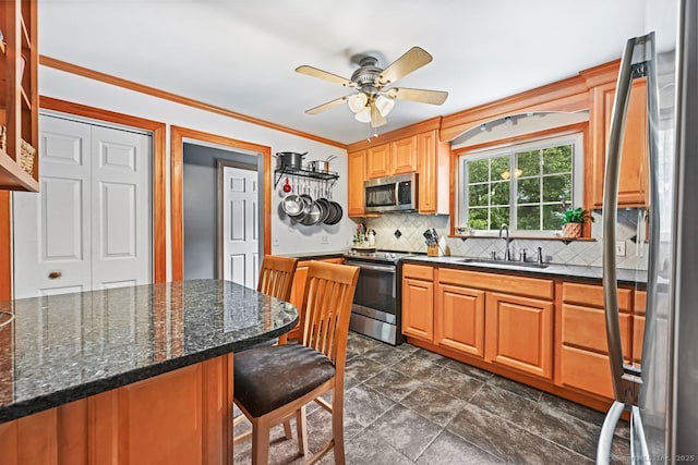 447 Howellton Rd, Orange, CT 06477 - kitchen featuring appliances with stainless steel finishes, tasteful backsplash, ceiling fan, a breakfast bar area, and crown molding