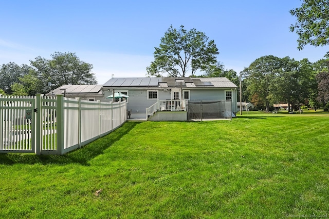 447 Howellton Rd, Orange, CT 06477 - rear view of property with solar panels and a wooden deck