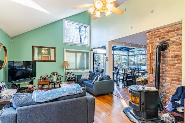 259 Weatherly Trl, Guilford, CT 06437 - living room featuring wood finished floors, a wood stove, a ceiling fan, and high vaulted ceiling