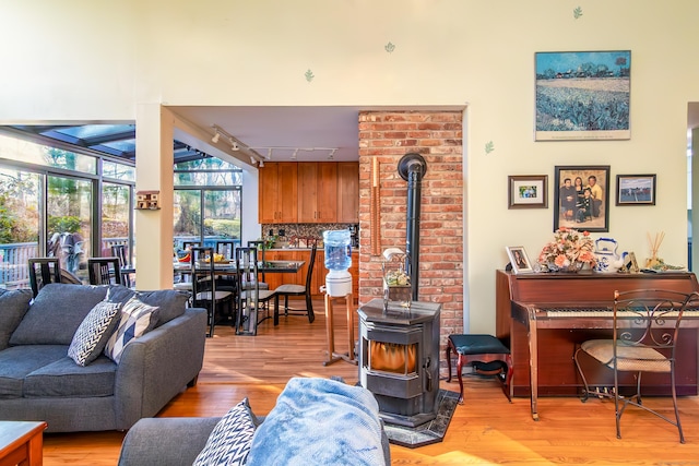 259 Weatherly Trl, Guilford, CT 06437 - living area with track lighting, a wood stove, and light wood-style flooring