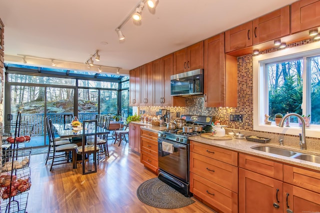 259 Weatherly Trl, Guilford, CT 06437 - kitchen featuring a sink, brown cabinets, stainless steel microwave, black gas range oven, and light stone countertops