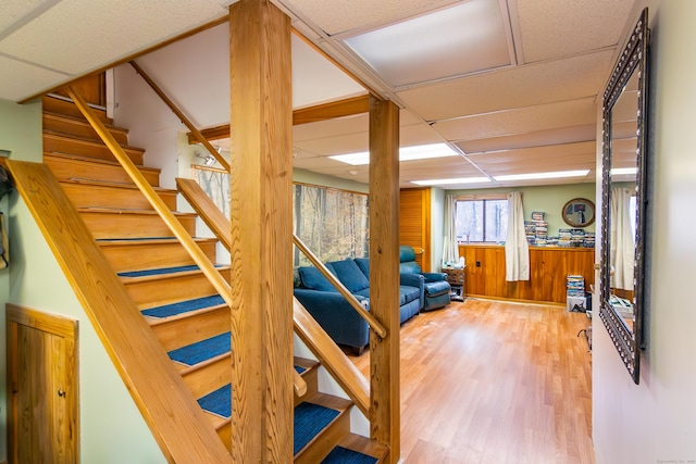 259 Weatherly Trl, Guilford, CT 06437 - stairway featuring wood walls, wood finished floors, and a drop ceiling