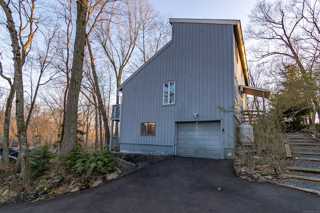 259 Weatherly Trl, Guilford, CT 06437 - view of side of home with an attached garage and aphalt driveway