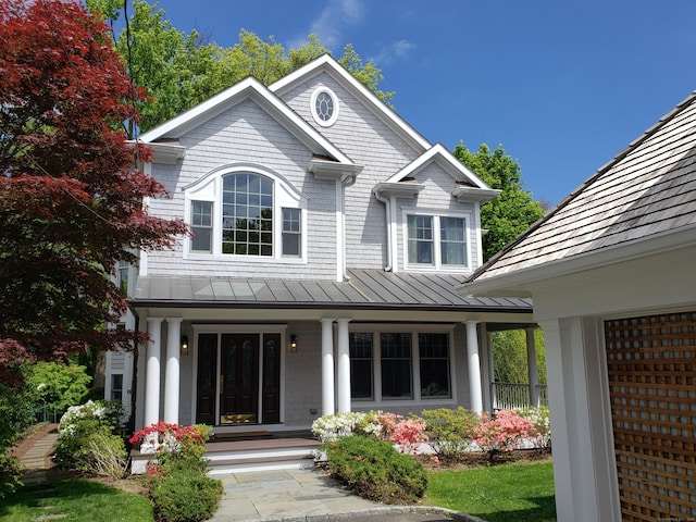 view of front of property with a standing seam roof, a porch, and metal roof