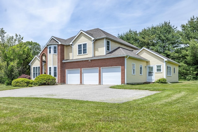 14 Fieldstone Dr, Mansfield, CT 06268 - view of front of home with asphalt driveway, a garage, a front lawn, and roof with shingles