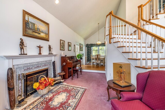 14 Fieldstone Dr, Mansfield, CT 06268 - carpeted living room with high vaulted ceiling, stairs, and a fireplace