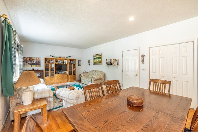 14 Fieldstone Dr, Mansfield, CT 06268 - dining room featuring a textured ceiling and wood finished floors