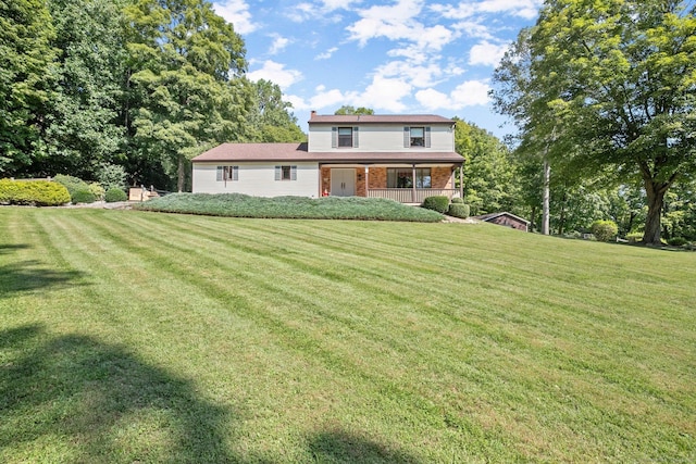 back of house featuring a lawn