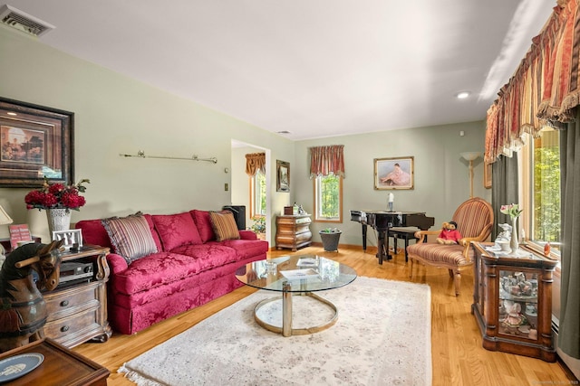 living area featuring light wood-style floors, visible vents, and recessed lighting