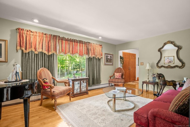 living area with light wood-type flooring, recessed lighting, and baseboard heating