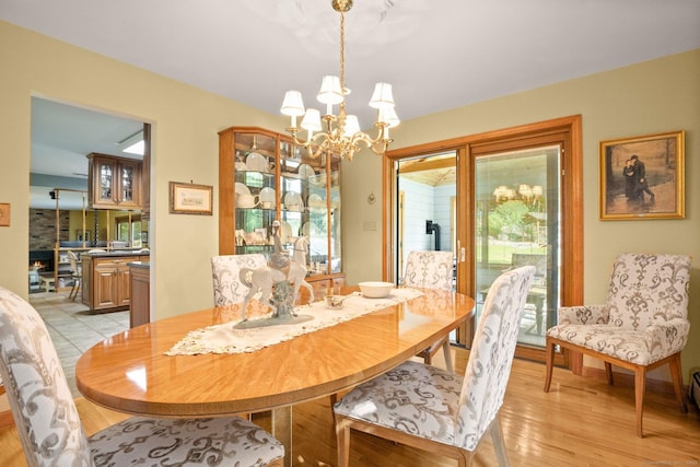 dining space with light wood-style flooring and a chandelier