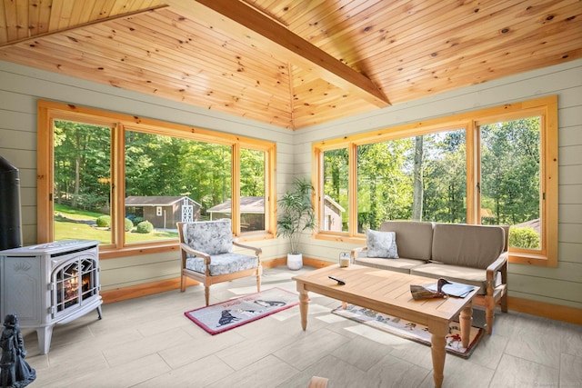 sunroom featuring wooden ceiling, wood walls, vaulted ceiling, and plenty of natural light
