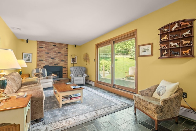 living area with baseboards, a baseboard heating unit, stone tile flooring, a brick fireplace, and visible vents