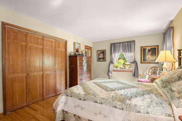 bedroom with light wood-type flooring and a closet