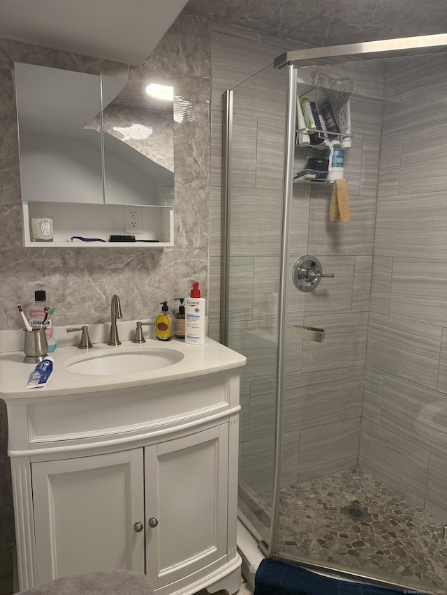 bathroom with vanity, tasteful backsplash, and a stall shower