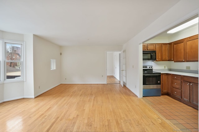 95 Audubon St Unit 222Aka 24, New Haven, CT 06510 - kitchen featuring stainless steel electric range, black microwave, light countertops, and light wood finished floors