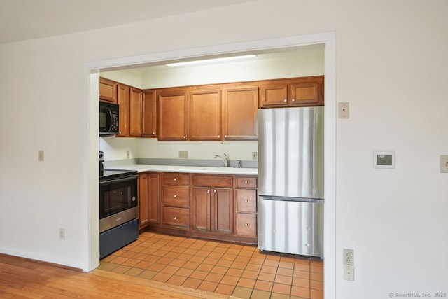 95 Audubon St Unit 222Aka 24, New Haven, CT 06510 - kitchen with a sink, light countertops, freestanding refrigerator, black microwave, and electric range
