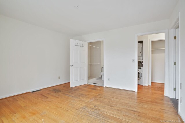 95 Audubon St Unit 222Aka 24, New Haven, CT 06510 - unfurnished bedroom with light wood-style floors, ensuite bath, a spacious closet, stacked washer / dryer, and baseboards