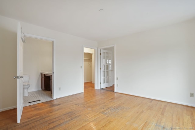 95 Audubon St Unit 222Aka 24, New Haven, CT 06510 - unfurnished bedroom featuring light wood-style floors, ensuite bath, a spacious closet, visible vents, and baseboards