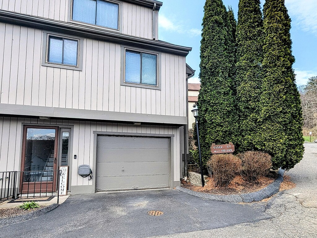 134 Essex Ct Unit 134, Beacon Falls, CT 06403 - view of home's exterior with a garage and aphalt driveway