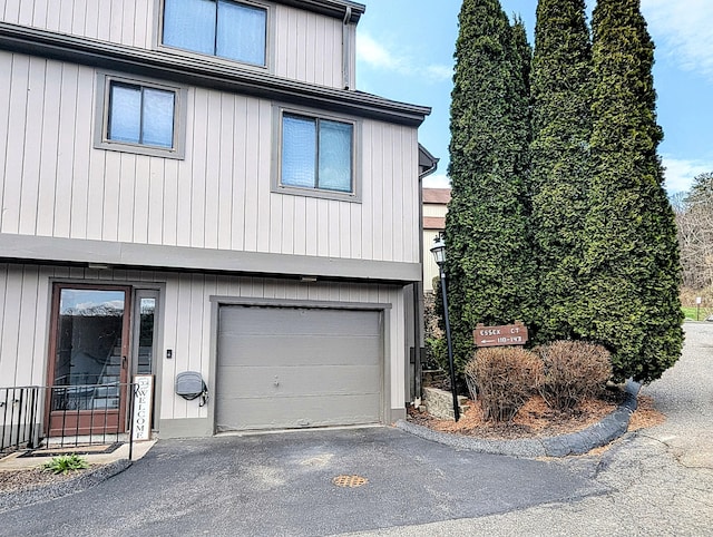 view of home's exterior with a garage and aphalt driveway