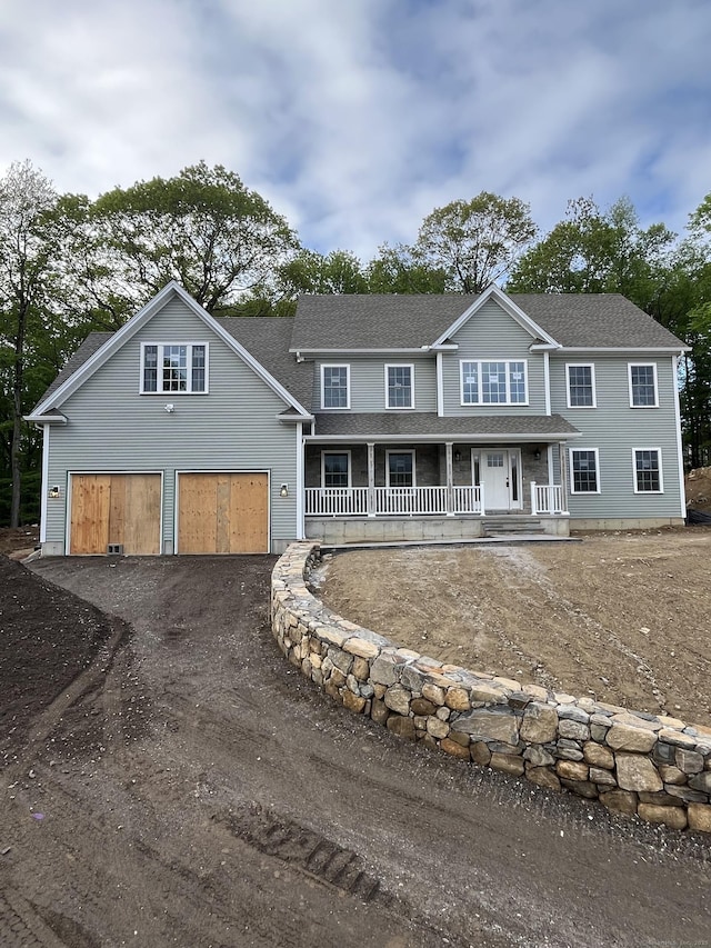 39 Platt Dr, Prospect, CT 06712 - colonial-style house with covered porch, asphalt driveway, an attached garage, and a shingled roof