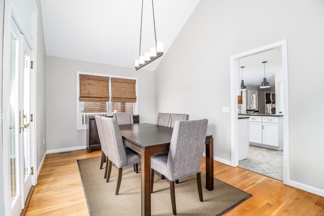5A Big Buck Ln, Brookfield, CT 06804 - dining area with light wood-type flooring, baseboards, lofted ceiling, and visible vents