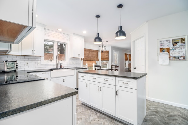 5A Big Buck Ln, Brookfield, CT 06804 - kitchen with pendant lighting, tasteful backsplash, white cabinetry, dark countertops, and baseboards