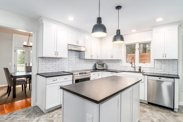 5A Big Buck Ln, Brookfield, CT 06804 - kitchen with white cabinetry, dark countertops, under cabinet range hood, stainless steel appliances, and a sink