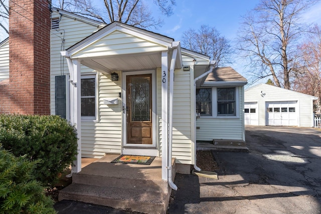 view of exterior entry featuring a detached garage