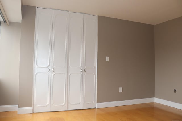 30 Woodland St Unit 5B, Hartford, CT 06105 - unfurnished bedroom featuring a closet, light wood-style flooring, and baseboards