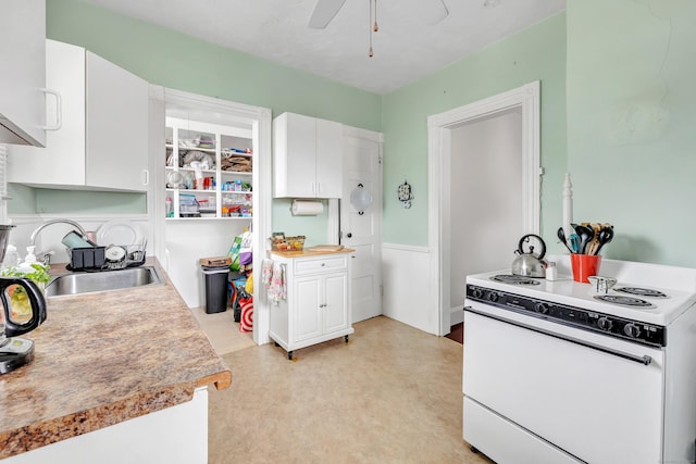 172 Prospect Ave, Shelton, CT 06484 - kitchen featuring light countertops, a ceiling fan, white cabinets, white electric range oven, and a sink