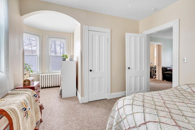 172 Prospect Ave, Shelton, CT 06484 - carpeted bedroom with arched walkways, baseboards, radiator, and a closet