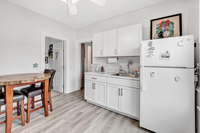 172 Prospect Ave, Shelton, CT 06484 - kitchen with freestanding refrigerator, a ceiling fan, white cabinets, light countertops, and a sink