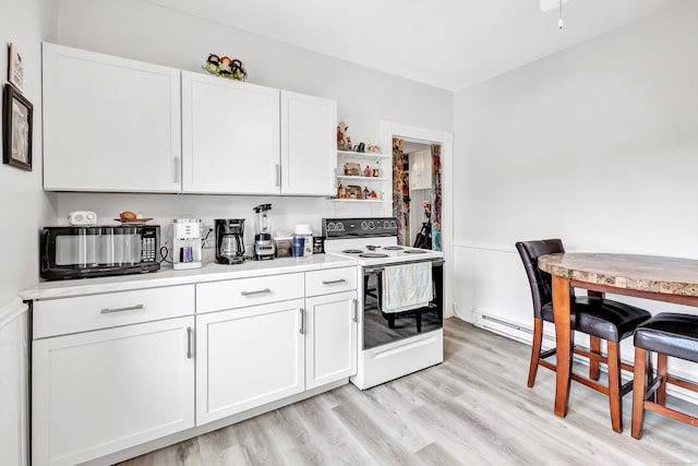 172 Prospect Ave, Shelton, CT 06484 - kitchen featuring white electric range, light wood finished floors, light countertops, and white cabinetry
