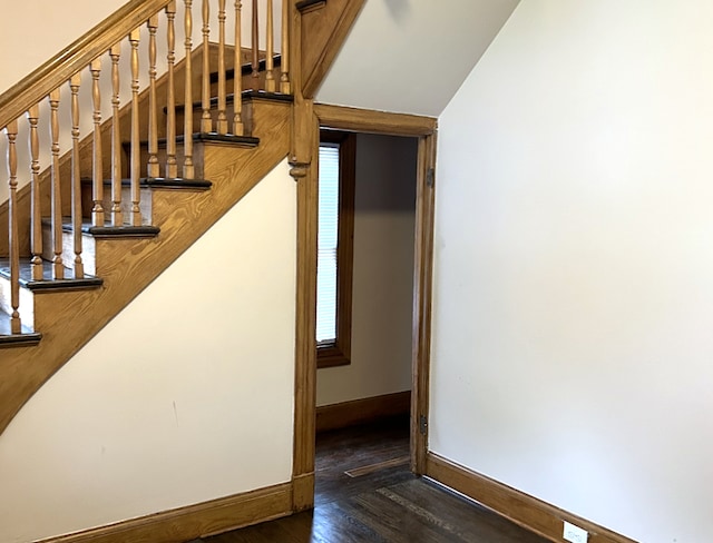 stairs with wood finished floors and baseboards