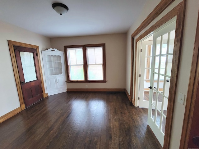 entrance foyer featuring dark wood-style floors, baseboards, and french doors