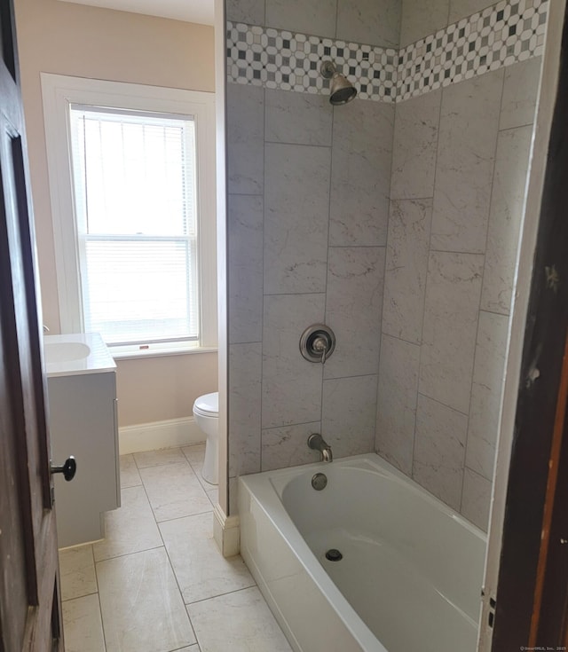 bathroom with vanity, baseboards, shower / bathing tub combination, and toilet