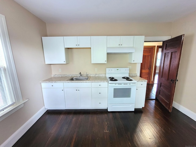 kitchen with baseboards, under cabinet range hood, a sink, and white range with electric cooktop