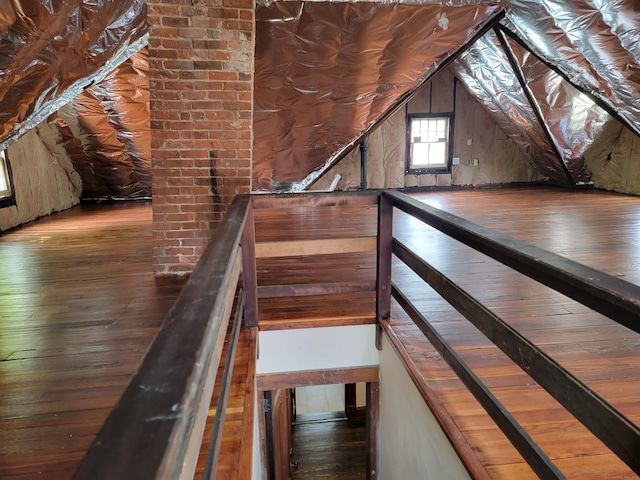 unfinished attic featuring an upstairs landing